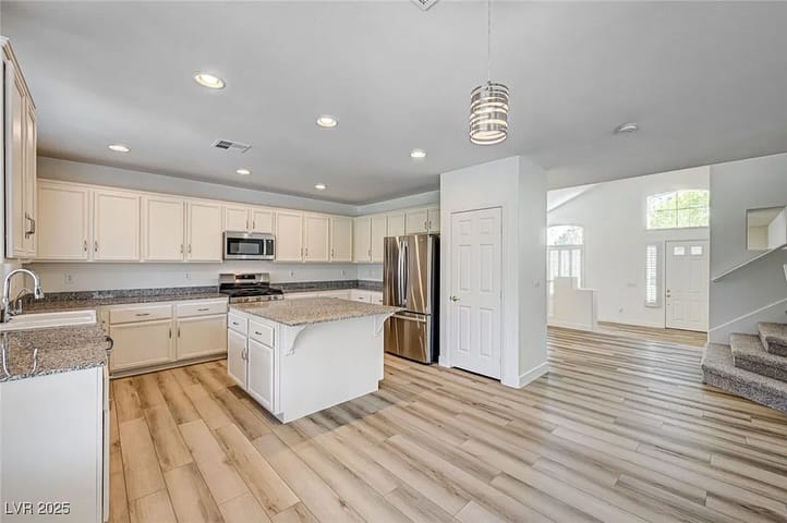 Open kitchen and staircase in a home sold by Park Place Realty, Las Vegas