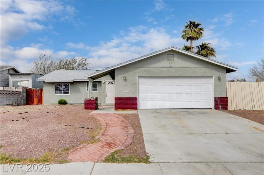 Single-story ranch home with brick accents and palms, sold by Park Place Realty, Las Vegas