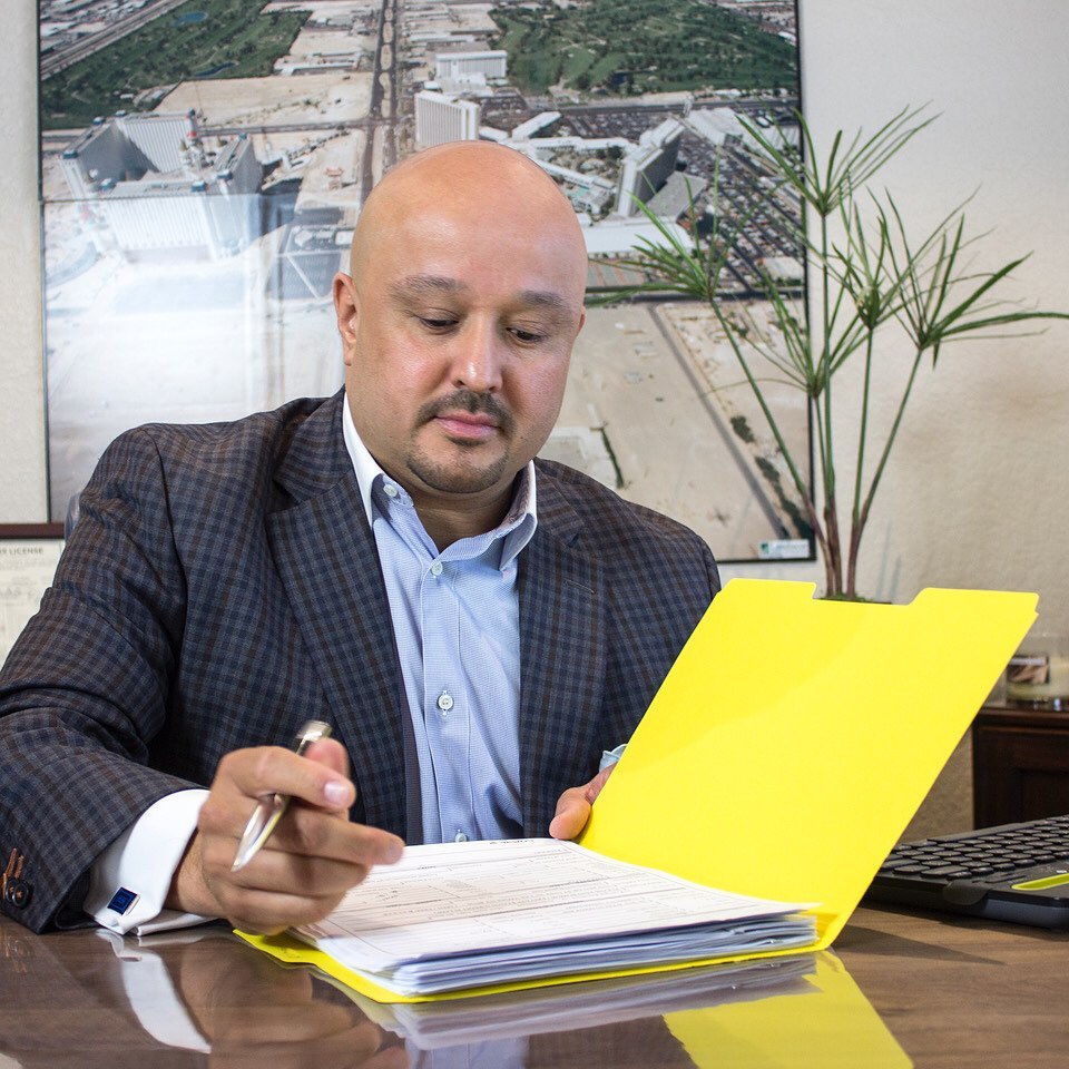 Jesse reviewing financial documents at his desk