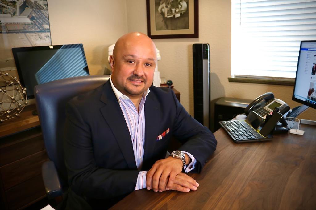 Jesse Fonseca at his desk in the Park Place Realty office on Jones Blvd.